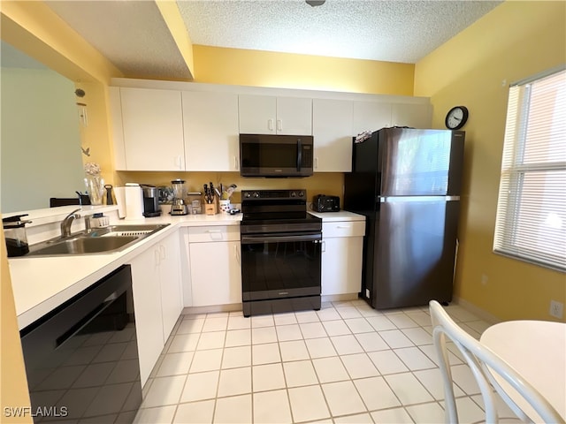 kitchen featuring white cabinetry, sink, black appliances, and a textured ceiling