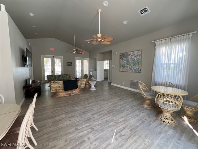 living room with ceiling fan, french doors, vaulted ceiling, and hardwood / wood-style flooring