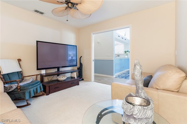 carpeted living room featuring ceiling fan