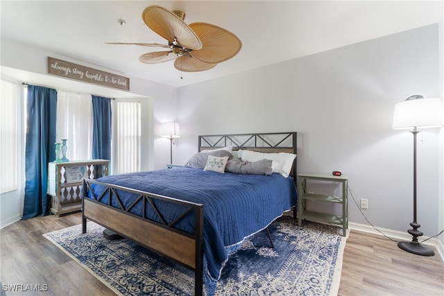 bedroom with hardwood / wood-style flooring and ceiling fan