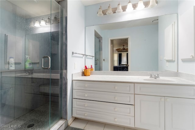 bathroom with tile patterned floors, vanity, and an enclosed shower