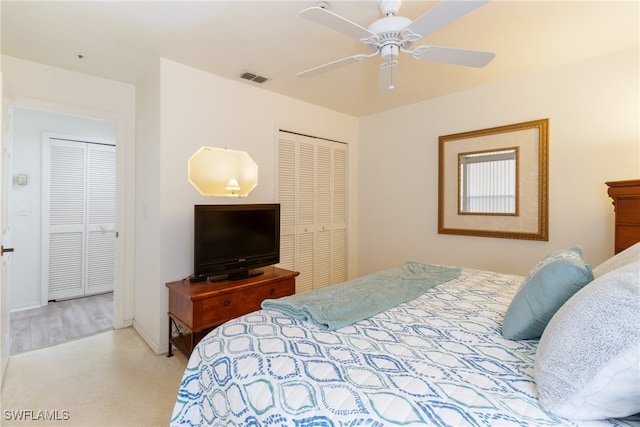 bedroom featuring light colored carpet and ceiling fan