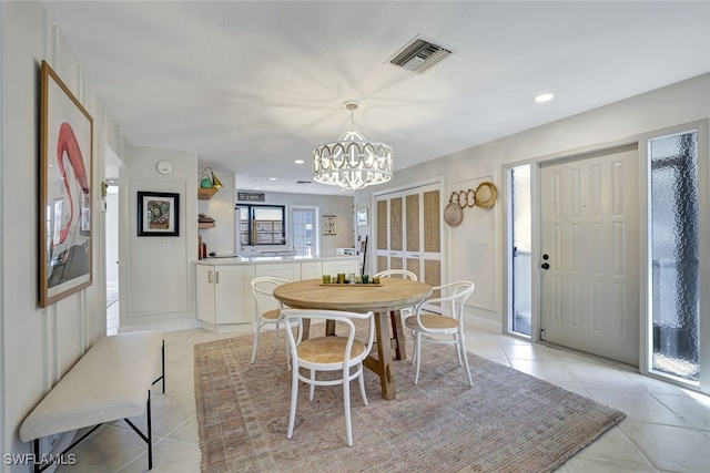 dining area featuring light tile patterned floors and a chandelier