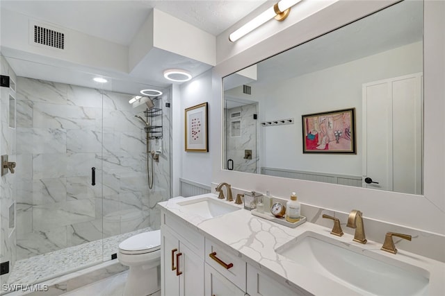 bathroom with vanity, toilet, and walk in shower