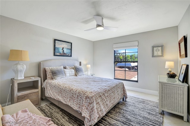 tiled bedroom featuring ceiling fan