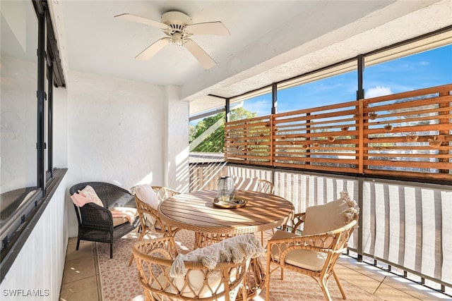 sunroom featuring ceiling fan