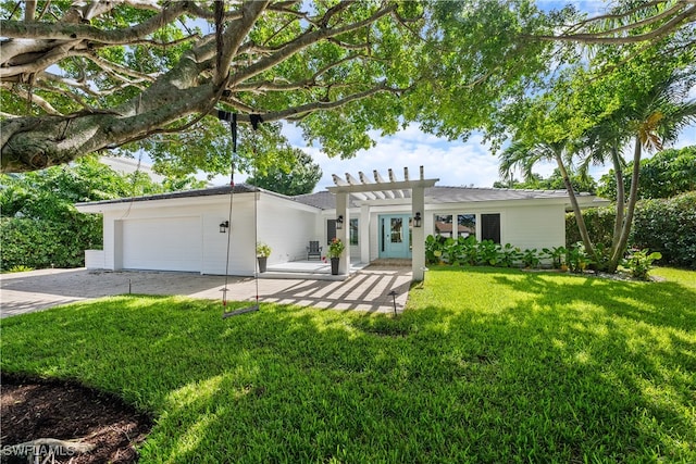 view of front of house featuring a front yard and a garage