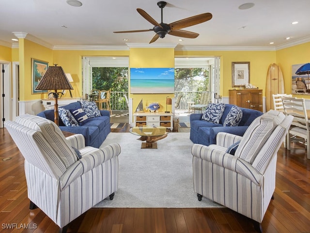 living room featuring dark hardwood / wood-style floors, ceiling fan, and ornamental molding