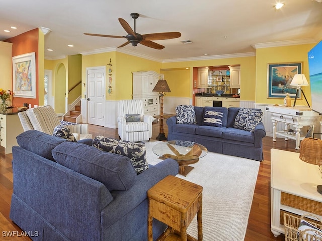 living room featuring ceiling fan, dark hardwood / wood-style flooring, and crown molding