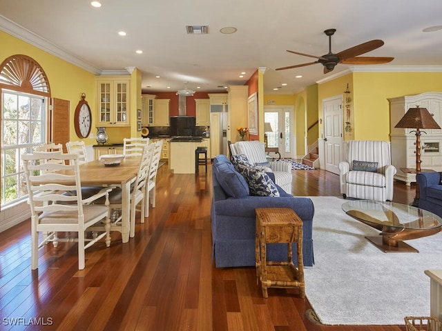 living room with ceiling fan, dark wood-type flooring, and ornamental molding