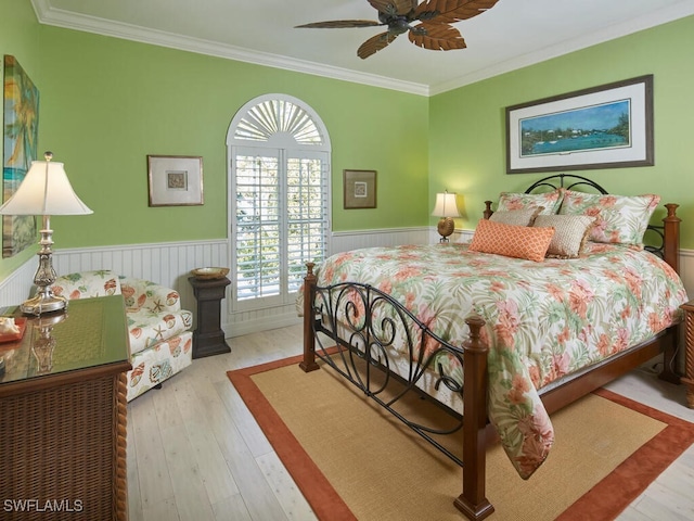 bedroom featuring light hardwood / wood-style floors, ceiling fan, and ornamental molding