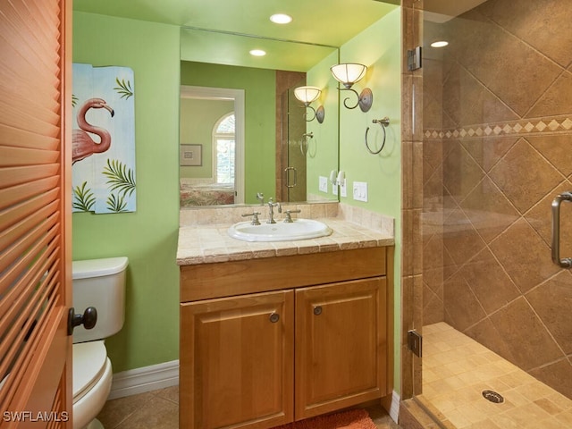 bathroom featuring tile patterned floors, vanity, toilet, and a shower with door