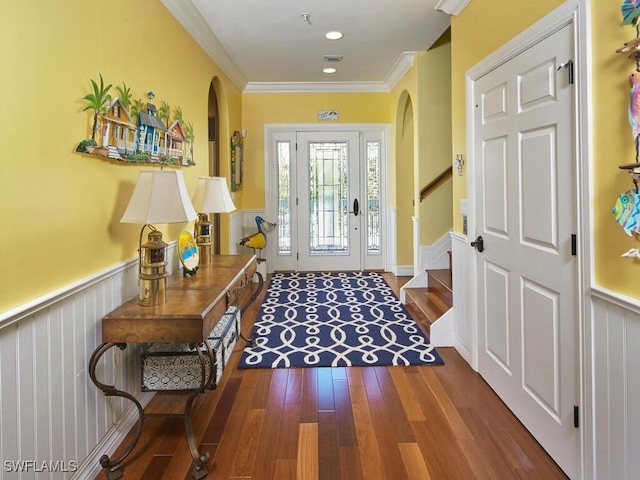 foyer with crown molding and hardwood / wood-style floors