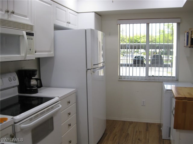 kitchen featuring white cabinets, dark hardwood / wood-style flooring, and white appliances