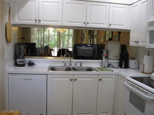 kitchen with white cabinets, white appliances, and sink