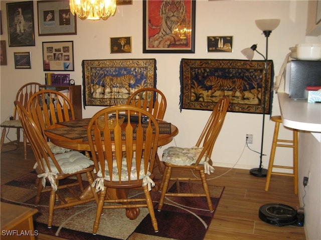 dining area featuring wood-type flooring and a chandelier