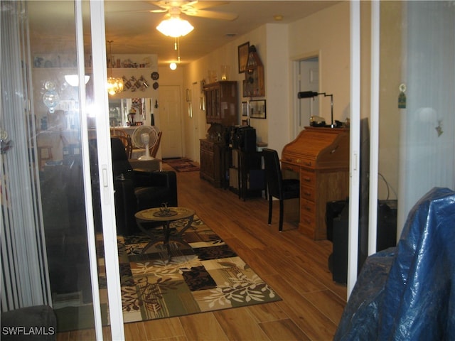 living room featuring ceiling fan and hardwood / wood-style flooring