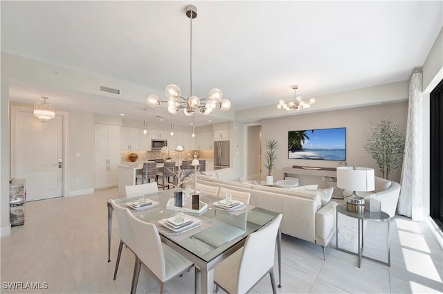 dining area featuring light tile patterned floors and a notable chandelier