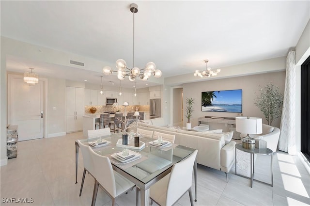 1111 Central Ave Unit 211, Naples, FL 34102 - dining room with a chandelier and light tile patterned floors