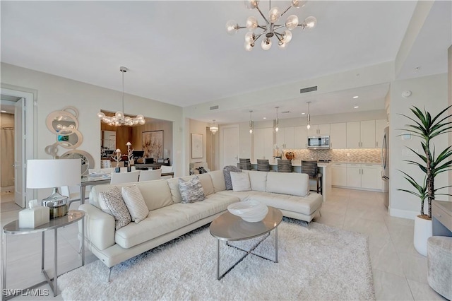 tiled living room featuring an inviting chandelier