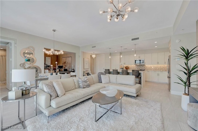 1111 Central Ave Unit 211, Naples, FL 34102 - living room with a chandelier and light tile patterned floors