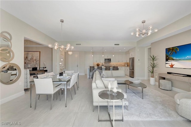 tiled living room with an inviting chandelier