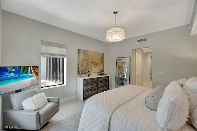 1111 Central Ave Unit 211, Naples, FL 34102 - bedroom with baseboards and light tile patterned floors