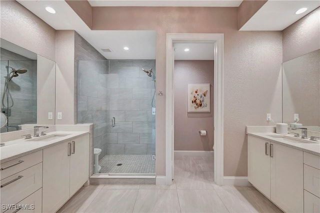 bathroom with tile patterned floors, vanity, and an enclosed shower