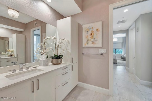 bathroom with tile patterned flooring and vanity