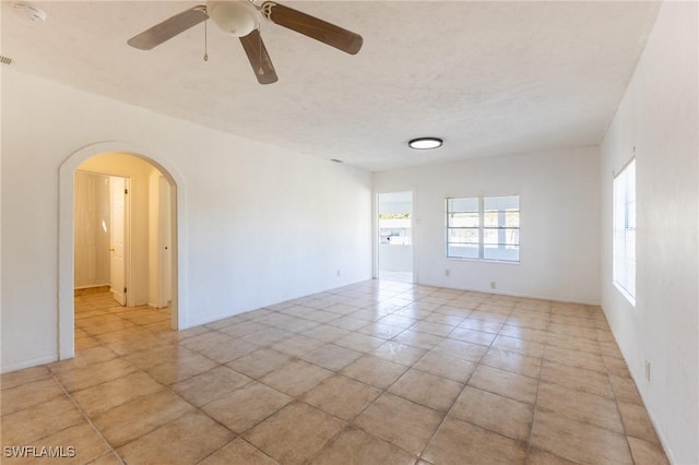 spare room featuring ceiling fan and light tile patterned flooring