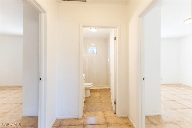 corridor featuring light tile patterned floors