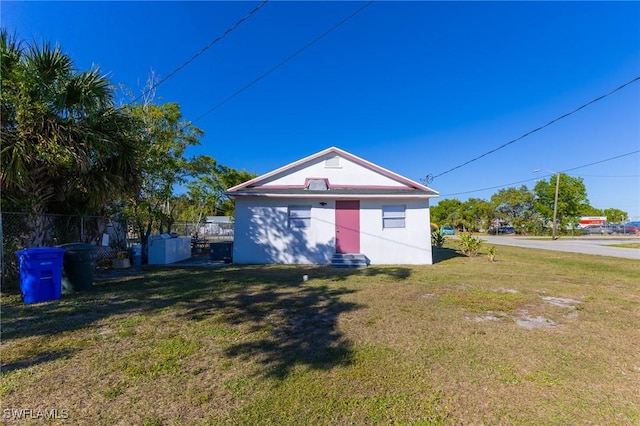 back of property featuring a lawn