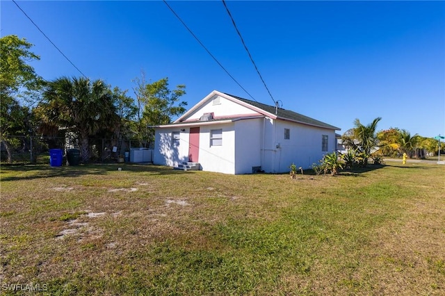 back of house with a lawn