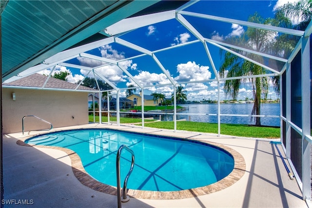 view of swimming pool featuring glass enclosure, a yard, a water view, and a patio