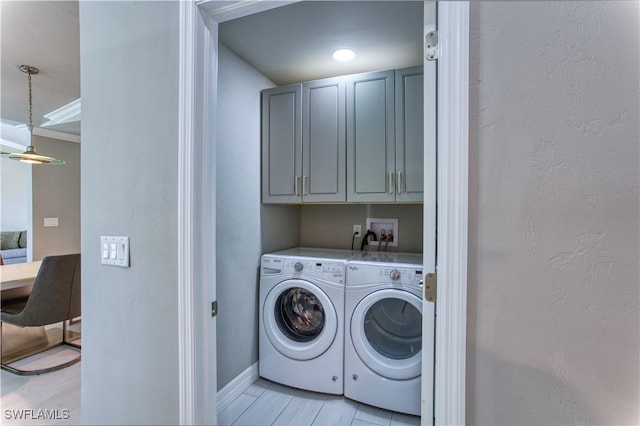 laundry room with cabinets and washing machine and clothes dryer