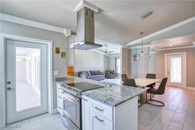 kitchen featuring light stone counters, crown molding, stainless steel electric stove, island range hood, and white cabinets