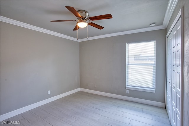 empty room with crown molding, ceiling fan, and light wood-type flooring