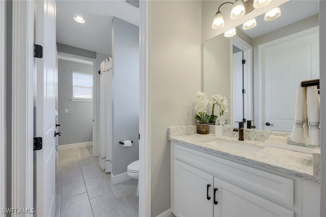 bathroom with vanity and toilet