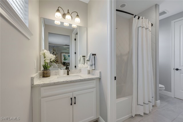 full bathroom featuring tile patterned floors, vanity, shower / bathtub combination with curtain, and toilet