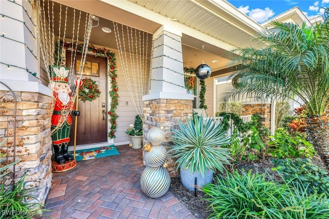 view of exterior entry with covered porch