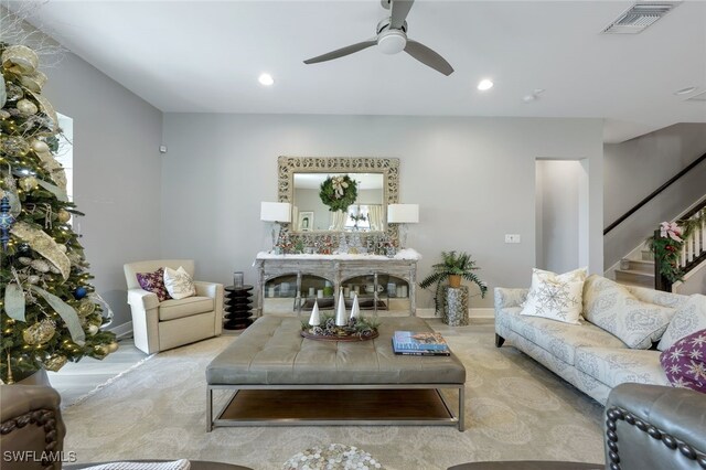 living room featuring a wealth of natural light and ceiling fan