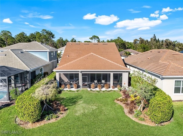 rear view of property with a yard