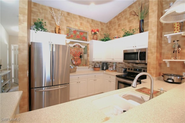 kitchen with sink, white cabinetry, stainless steel appliances, and tasteful backsplash