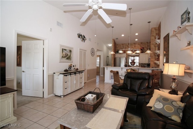 tiled living room featuring high vaulted ceiling and ceiling fan