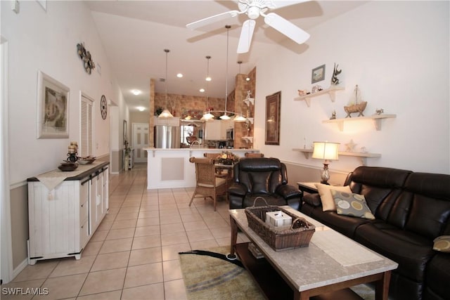 tiled living room featuring a towering ceiling and ceiling fan