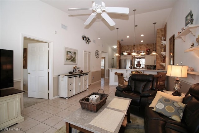 tiled living room with high vaulted ceiling and ceiling fan