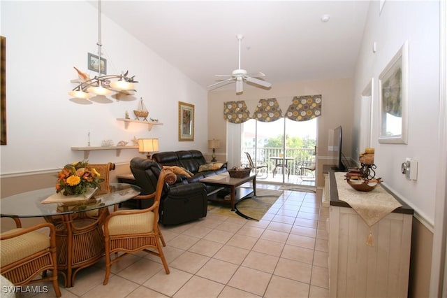 living room with light tile patterned floors, vaulted ceiling, and ceiling fan