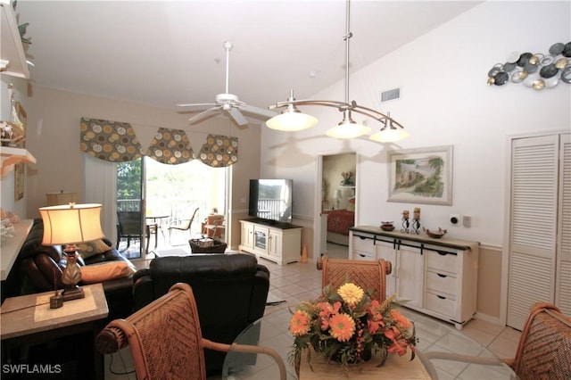 tiled living room with ceiling fan and lofted ceiling