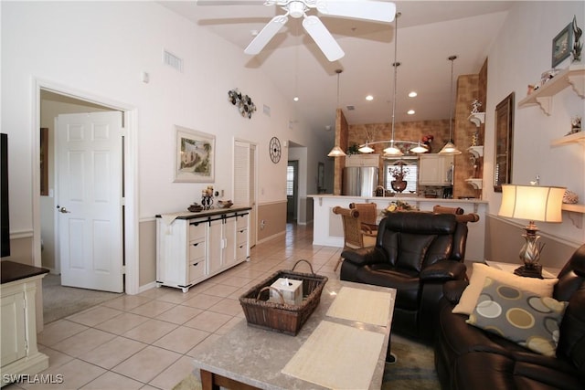 living room featuring light tile patterned floors, high vaulted ceiling, and ceiling fan