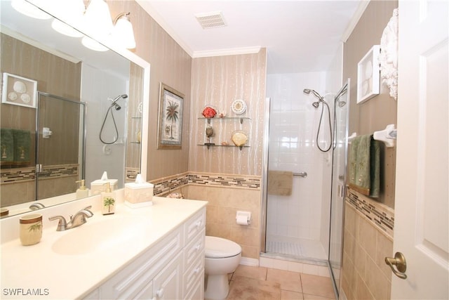 bathroom with vanity, a shower with door, tile patterned flooring, toilet, and ornamental molding